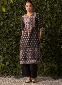 Angled front view of a refined womenâ€™s embroidered kurta with intricate detailing, three-quarter sleeves and chic silhouette.