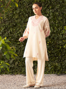 Front view of a womanÃ¢â‚¬â„¢s embroidered kurta with intricate patterns, three-quarter sleeves, and a graceful silhouette.