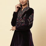 Velvet top is featured with full sleeves and mandarin collar, multi-colored floral motifs, gold dori, and sequin highlights