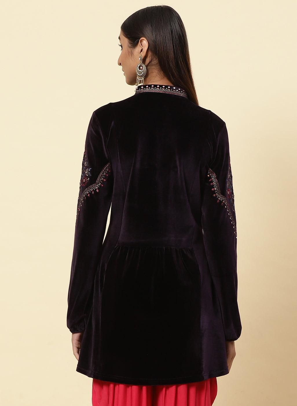 Rear view of the Plum Velvet Flared Tunic with elegant gold dori and sequin accents, modeled by Lakshita
