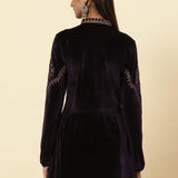Rear view of the Plum Velvet Flared Tunic with elegant gold dori and sequin accents, modeled by Lakshita