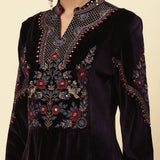 The expanded view of a model wearing Velvet tunic with mandarin collar, multi-colored floral motifs, and gold dori.