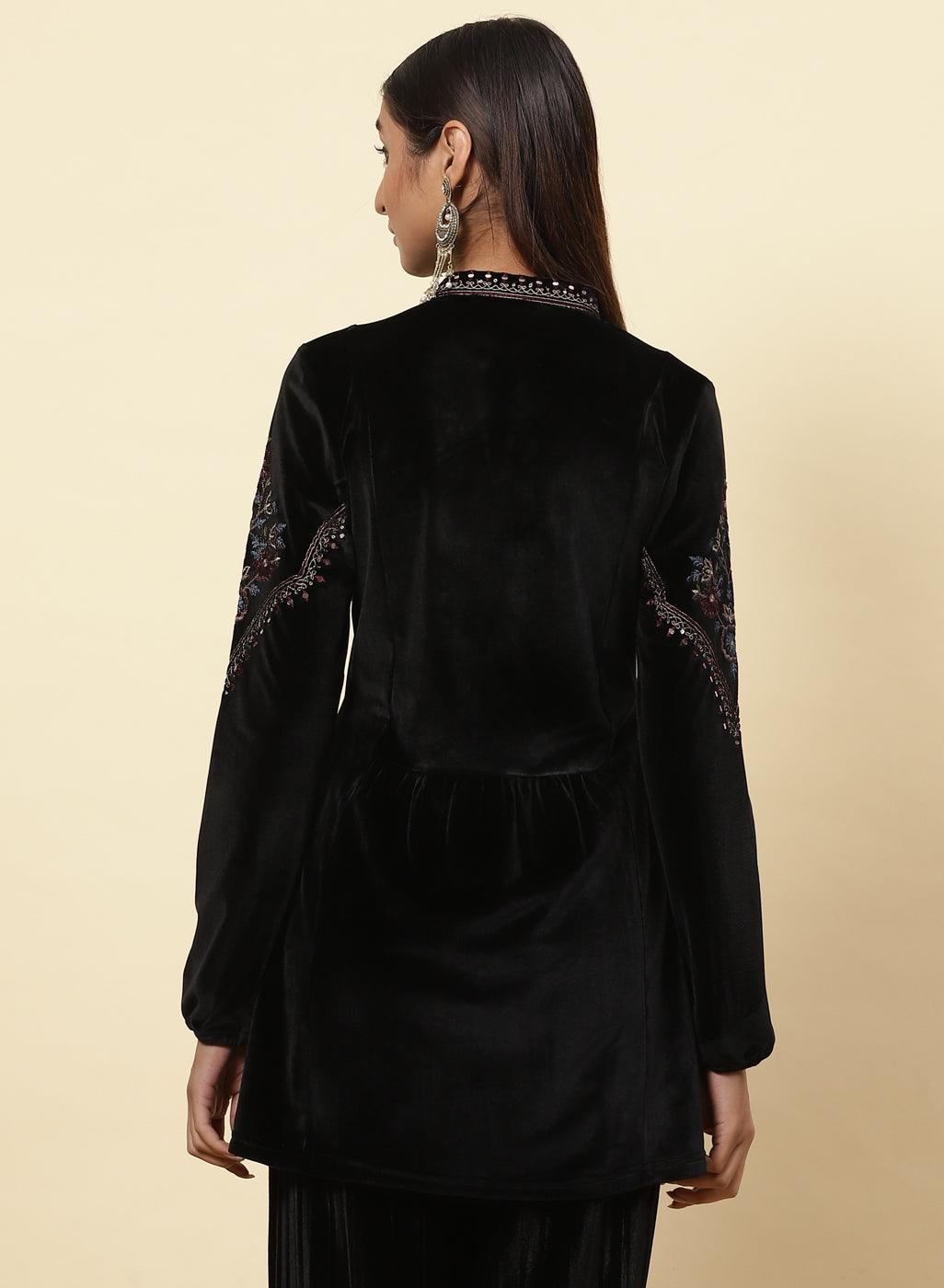 The model poses from the back, showcasing the Charcoal Black Velvet Flared Tunic of Lakshita