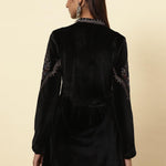 The model poses from the back, showcasing the Charcoal Black Velvet Flared Tunic of Lakshita