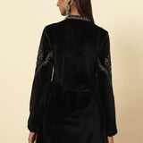 The model poses from the back, showcasing the Charcoal Black Velvet Flared Tunic of Lakshita