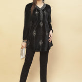 Model pairing Charcoal Black Embroidered Velvet Tunic With Sequins with a silver clutch