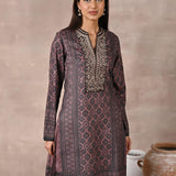 Model smiling in Brown Velvet Kurta Set with Zari & Sequin Work