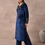 Woman presents the left side of the Navy Blue Velvet Kurta With Fine Mirror Work