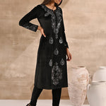 A model posing in Black Velvet Kurta With Fine Mirror Work