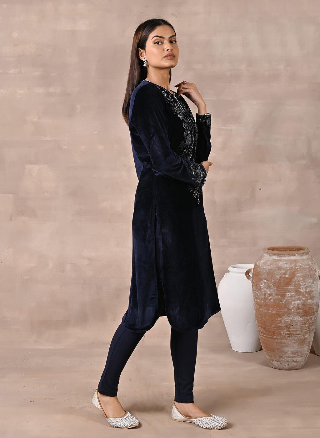 Woman walking sideways in Navy Blue Velvet Kurta with Fine Mirror Beads Work