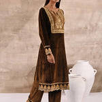 The model is posing with a Golden Velvet Kurta with matching trousers and  footwear