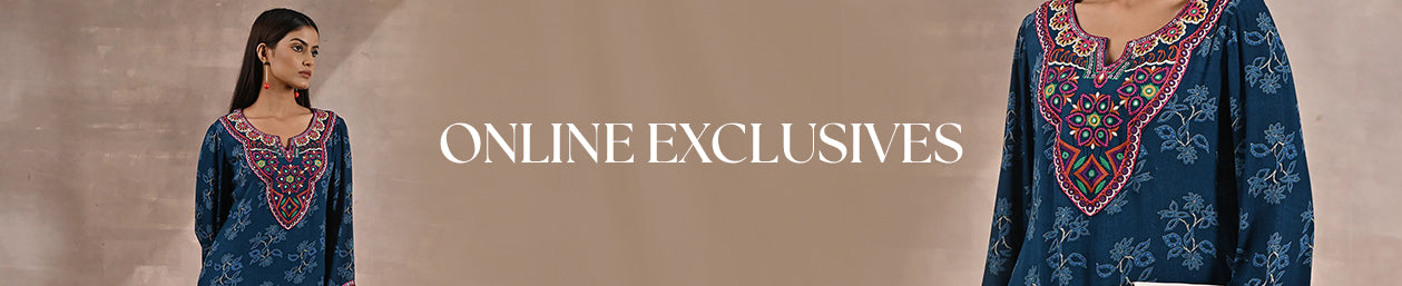 Model in elegant pastel ethnic wear standing by sandstone architecture, spotlighting an Online Exclusive drop