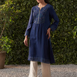 The model is posing with Lakshita's navy blue embroidered cotton gauze kurta