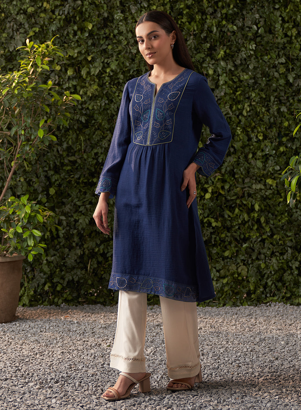 The model is posing with Lakshita's navy blue embroidered cotton gauze kurta