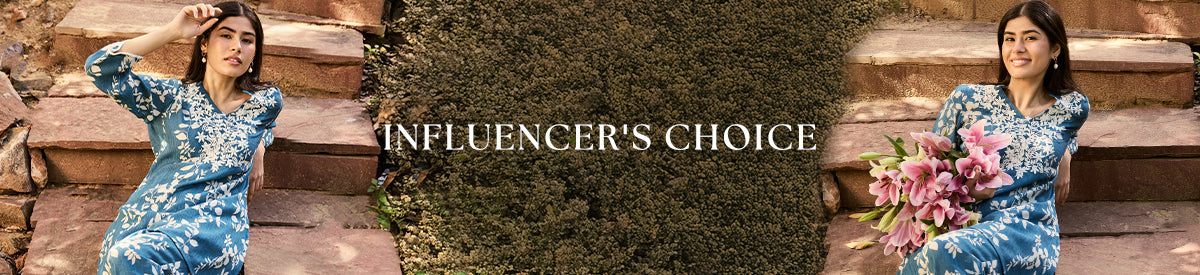 Model in a stylish indigo outfit holding lilies, embodying effortless grace from the Lakshita Influencer’s Choice edit