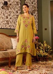Woman wearing pista green kurta with resham embroidery slit neck mid sleeves paired with matching pista green trousers
