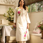 Front view of Lakshita Ulfat Pearl Ivory Set with pink rose embroidery on chest and hem, showcasing cotton linen fabric.