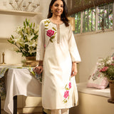 Front view of Lakshita Ulfat Pearl Ivory Set with pink rose embroidery on chest and hem, showcasing cotton linen fabric.