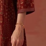 The image focuses on The printed piping detail of Lakshita’s Nyla Maroon Printed Co-ord Set 