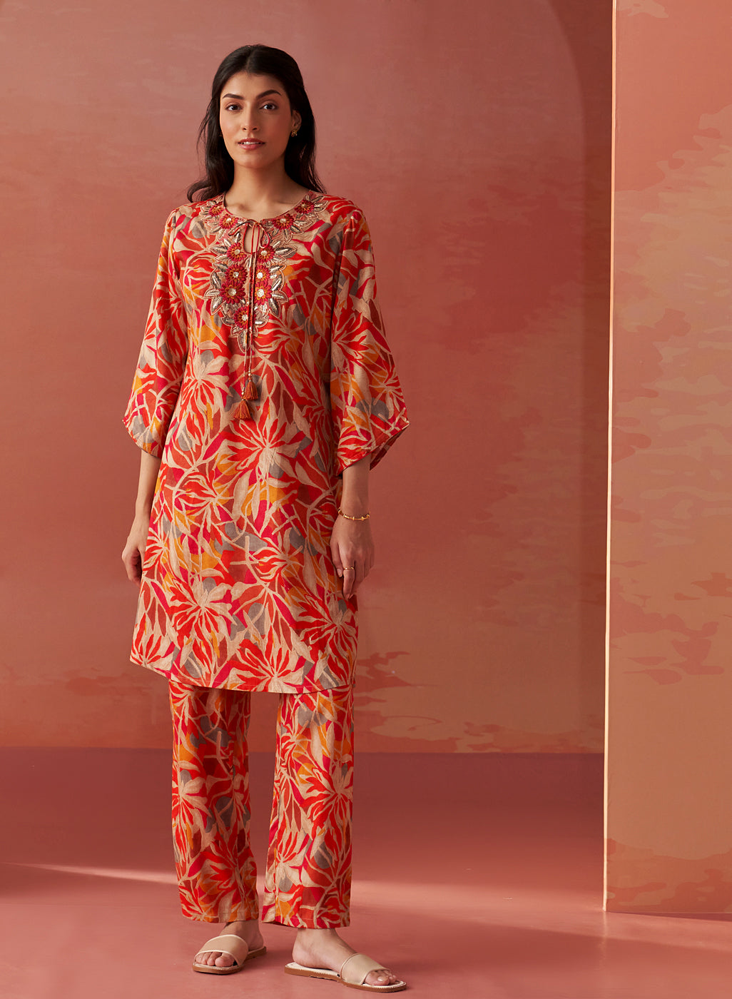 Front view of the Emaira orange printed rayon co-ord set for women featuring resham embroidery and tie-up tassel detail