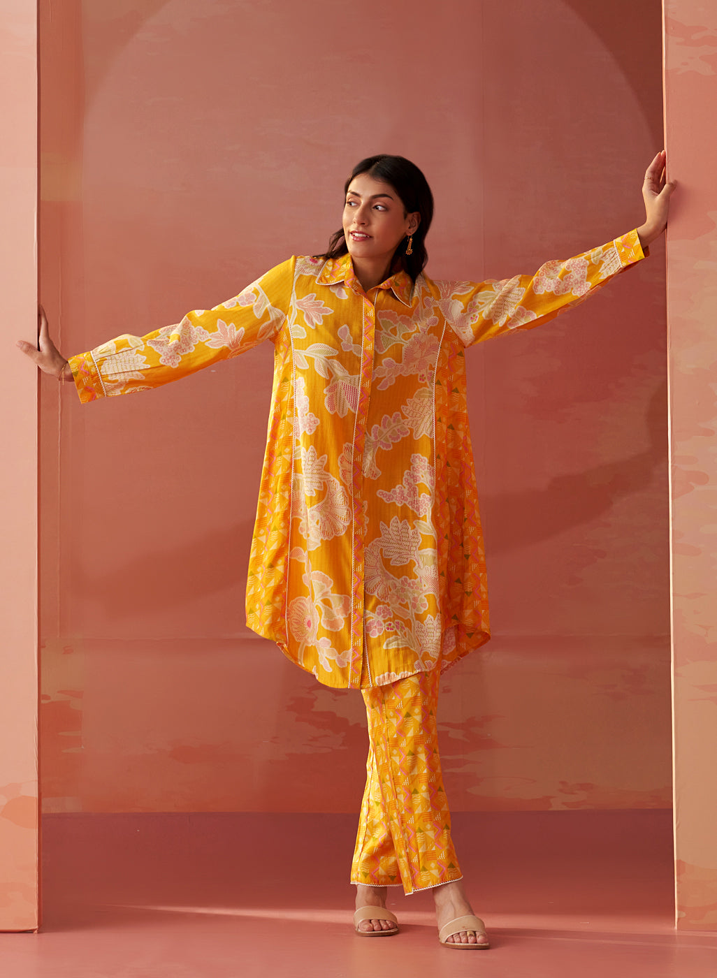 Model showcases angled side pose in Seher bright yellow Chanderi co-ord set with floral prints and comfortable fit.