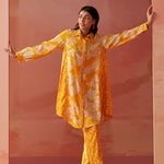 Model showcases angled side pose in Seher bright yellow Chanderi co-ord set with floral prints and comfortable fit.