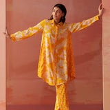 Model showcases angled side pose in Seher bright yellow Chanderi co-ord set with floral prints and comfortable fit.