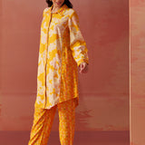 Angled profile of yellow floral printed Chanderi co-ord set for women with long collared kurta and straight printed pants.