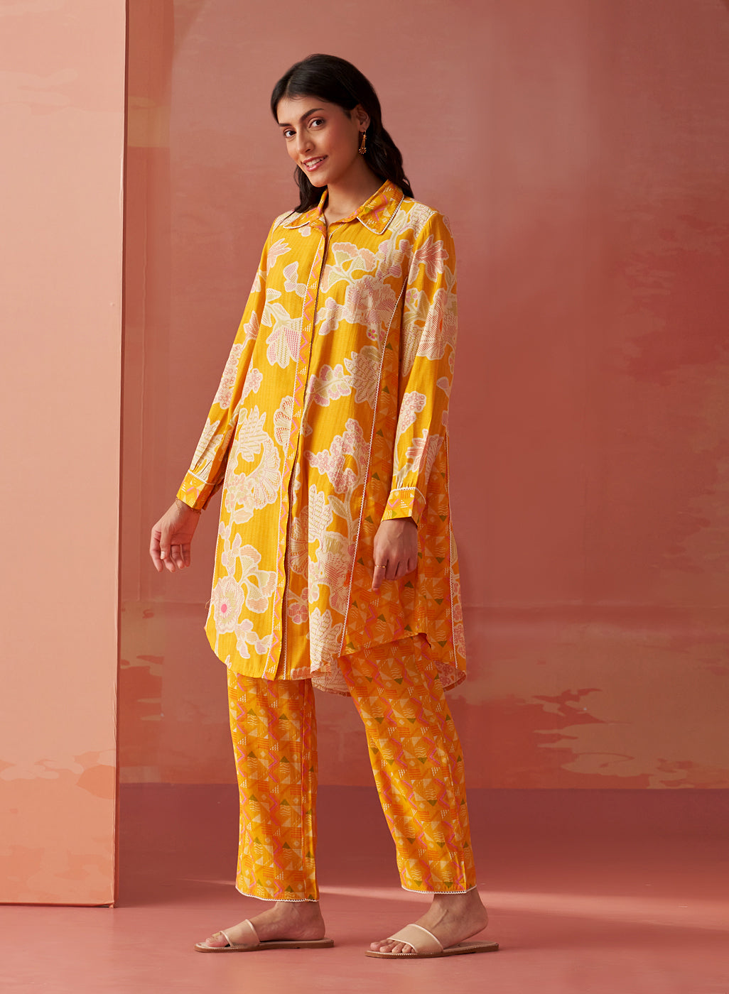 Model in side pose wearing bright yellow printed Chanderi co-ord set with collared kurta and geometric printed pants.