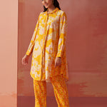 Model in side pose wearing bright yellow printed Chanderi co-ord set with collared kurta and geometric printed pants.