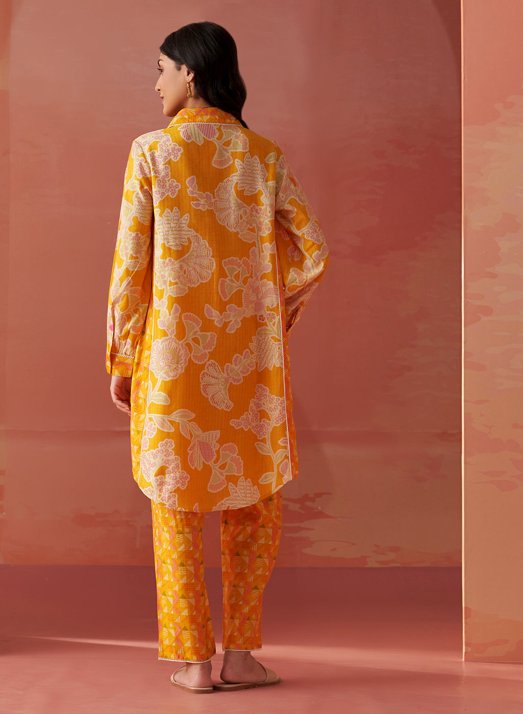 Close-up of Seher bright yellow printed Chanderi co-ord set highlighting floral motifs, collared neckline, and sleeve detail.