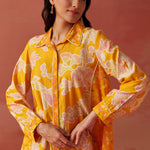 Close-up of Seher bright yellow printed Chanderi co-ord set highlighting floral motifs, collared neckline, and sleeve detail.