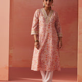 The model is posing with Lakshita's Rumaisa Orange Printed Chanderi Jacquard Co-ord Set