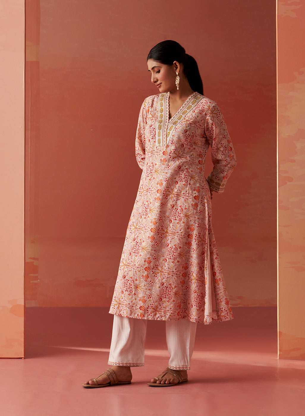 Dressed in Lakshita’s Rumaisa Co-ord Set, the model stuns in vibrant orange Chanderi Jacquard