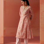 Dressed in Lakshita’s Rumaisa Co-ord Set, the model stuns in vibrant orange Chanderi Jacquard