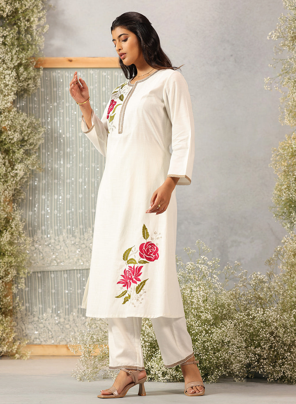 Full-length view of Ulfat Pearl Ivory Kurta Set featuring pink rose embroidery along the edge and soft cotton linen fabric.
