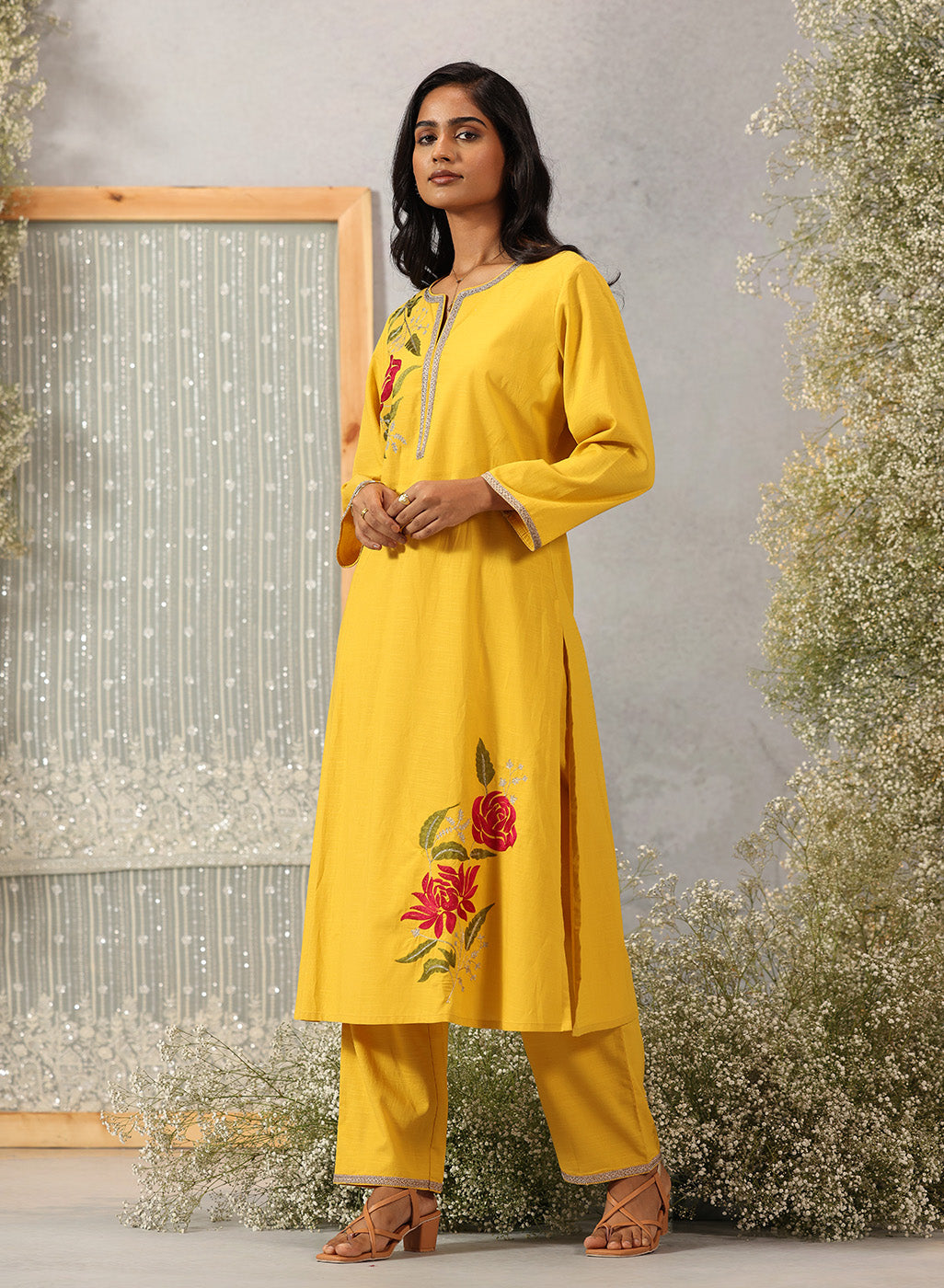 Lakshita Ulfat Sunflower Yellow Kurta Set showing front-side profile with silk thread motifs, zari lace trims.
