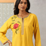 Waist-up close-up of Lakshita Ulfat Yellow Kurta Set showing red rose embroidery on the chest with zari accents.
