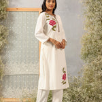 Model in Lakshita Ulfat Pearl Ivory Kurta Set turned sideways, showing floral embroidery and drape of cotton linen fabric.