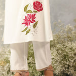 Waist-down view of Ulfat Pearl Ivory Kurta with pink rose motif on edge and zari-detailed hem of solid cotton linen pants.