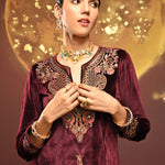A model flaunts in Mayal Maroon Embroidered Velvet Kurta Set