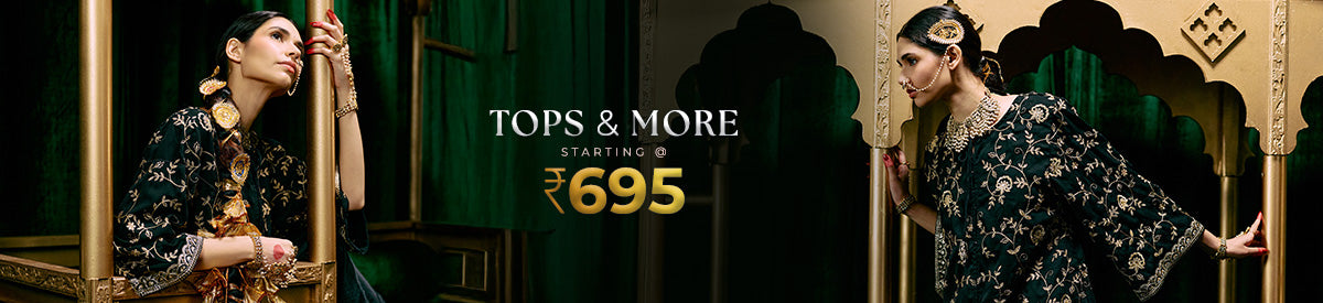 Woman in deep olive green tunic with lace sleeves stands gracefully near a doorway, defining modern casual chic