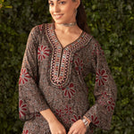 Close-up of model in black printed kurta with V-neck and bell sleeves, styled with silver jewelry