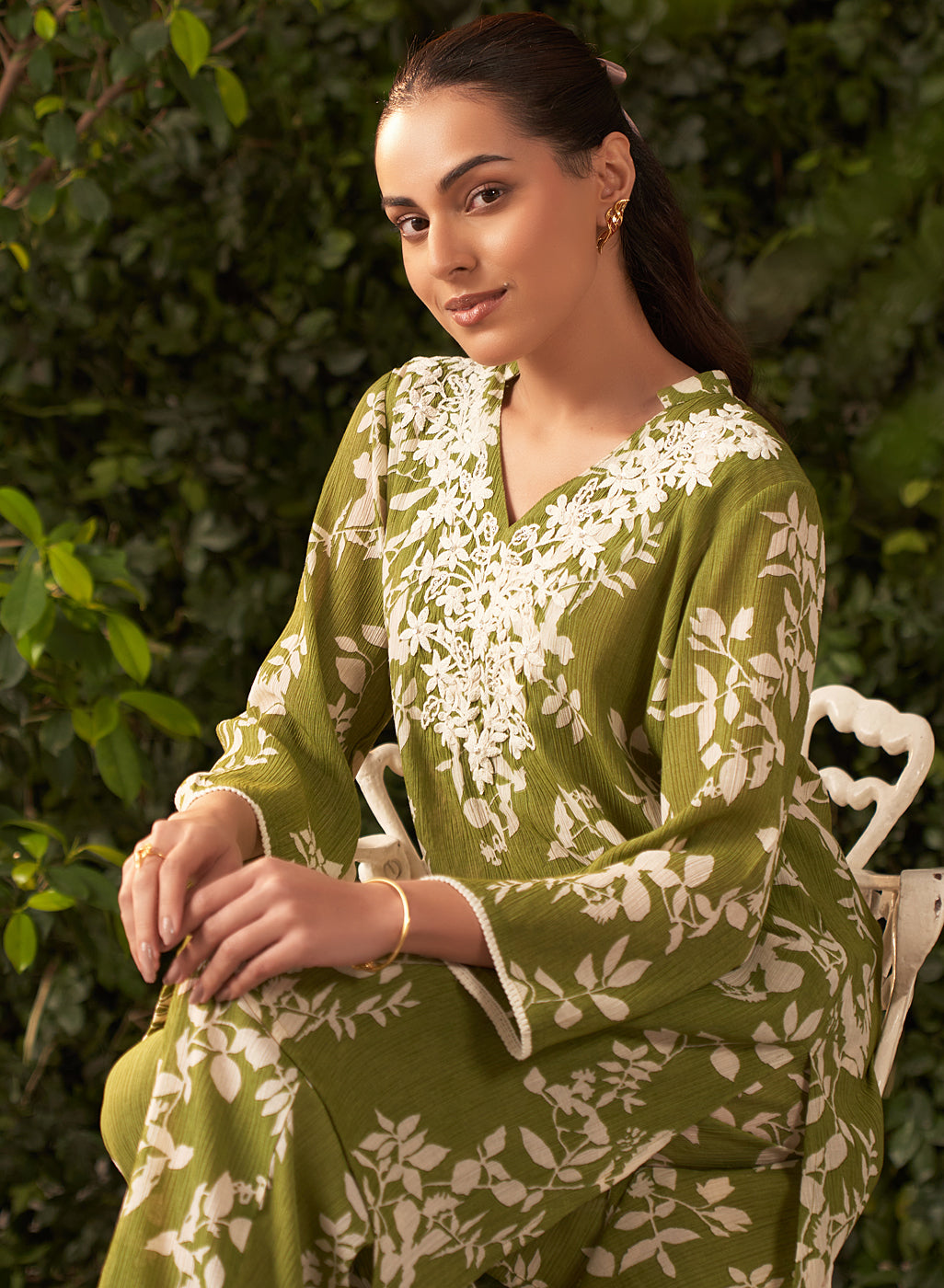 Seated model in Liliana lime green printed co-ord set featuring white floral embroidery on textured crinkled crepe fabric.