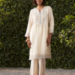 The model with a smiling face is wearing Lakshita’s Grace ivory embroidered cotton kurta