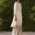 Side View of a woman wearing Lakshita’s Grace ivory embroidered cotton gauze kurta