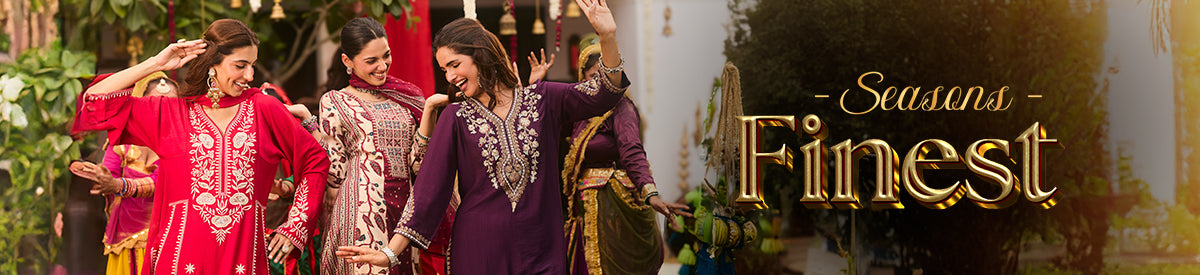 Two women in embroidered purple kurtas sharing a joyful moment while exploring the city – New Arrivals Collection