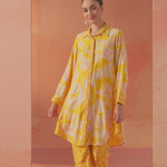 Full-length front view of Seher bright yellow printed Chanderi co-ord set with floral motifs and soft pastel backdrop.