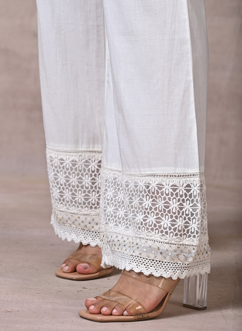 Off White Palazzos With Shimmery Details At The Hems