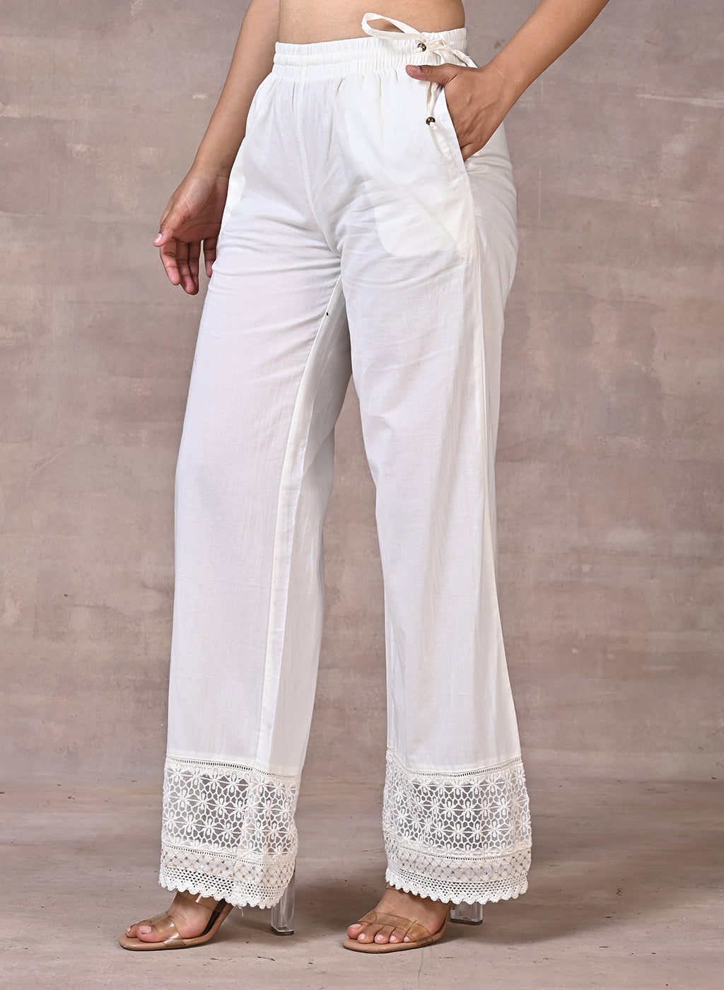 Off White Palazzos With Shimmery Details At The Hems
